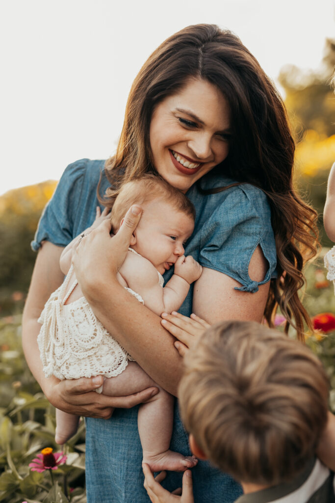 Home & Haven, Jennifer, holding her youngest of 5 children, homeschooler, christian, bible-believing curriculum maker